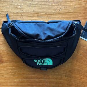 The NorthFace belt bag black with green writing new with tags